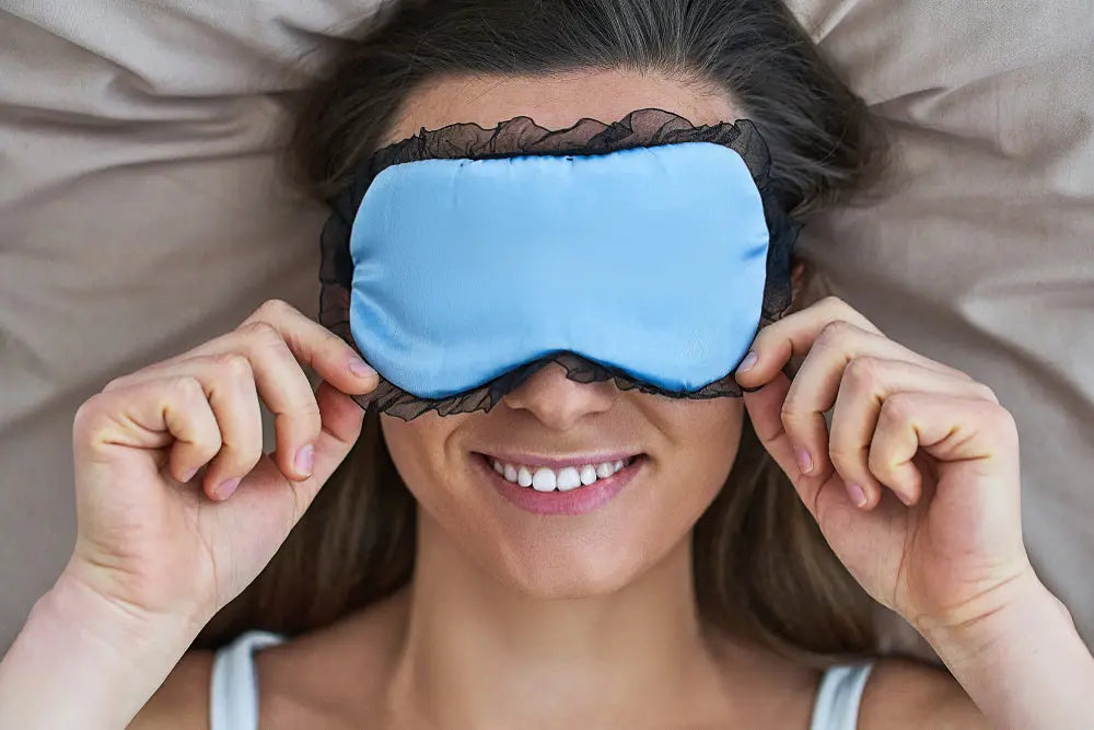 Happy smiling joyful sleeping woman wearing eye mask for better sleep and sweet dreams