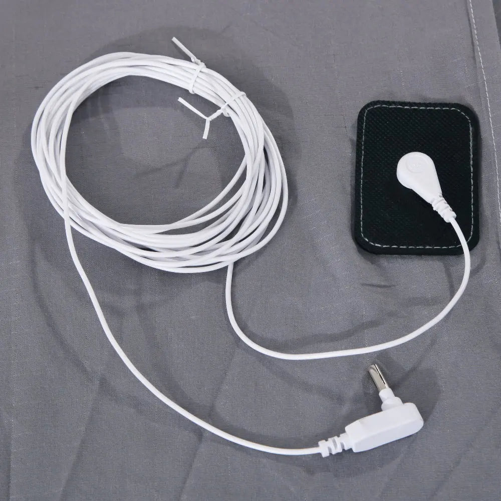 White cable with a plug on a gray fabric background